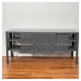 ENTERTAINMENT CONSOLE | Metal mesh with two shelves behind a pair of sliding doors; h. 22 x 48 x 15-
