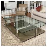 CHROME & GLASS LOW TABLE | Crossed chrome supports with a tempered glass top; h. 16 x 67 x 47 in.