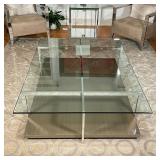CHROME & GLASS LOW TABLE | Crossed chrome supports with a tempered glass top; h. 16 x 67 x 47 in.