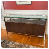 CONTEMPORARY CREDENZA | Having a tempered glass top on a chrome frame over a floating cabinet with f