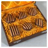 boxes designed in contrasting woods, including one each in the shape of a heart, triangle, oval, rec