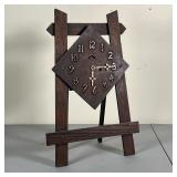 WOOD CLOCK ON STAND | Wood clock on an easel stand, marked "New Haven Clock Co." on the back