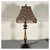 TABLE LAMP | Heavy metal lamp with fabric shade and beaded tassels; pineapple finial; h. 27 x 11 in.