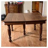 OAK DINING TABLE | Amish style oak dining table with turned fluted legs and three 1-ft extension lea