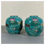 PAIR CHINESE DECORATIVE JARS | Jade green ceramic jars with lotus and stork motifs; maker