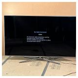 SAMSUNG 64.5" FLAT SCREEN TV | Model no. UN65F7100AF, with chrome silver quad stand; tested and turn