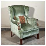 FANCY VELVET WINGCHAIR | Finely upholstered in green velvet with tassels on the handholds and a matc