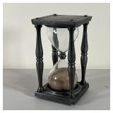 BLOWN GLASS HOURGLASS | In a chased pewter frame with velvet pads mounting the hourglass; h. 7 x 4 x