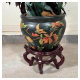 Planter decorated with birds among flowers, with a faux plant, both appearing in very good condition