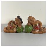 PAIR THAI CARVED WOOD FIGURES | Carved, painted, and decorated wood figures, a boy and a girl restin