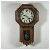 REGULATOR WALL CLOCK | Antique octagonal wall clock with contrasting wood paneling, the face with pa