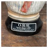 Liquor Bottle 185, created by Paul A. Lux 1976, with a lift off top hat lid; h. 11 in.