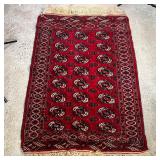 BOKHARA RUG | With a red ground; 5 ft. 2 in. x 3 ft. 6 in. [some discoloration to one end]