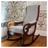 UPHOLSTERED ROCKING CHAIR | Antique carved wood rocking chair with cushioned seat, backrest, and arm