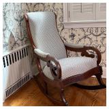 rocking chair with cushioned seat, backrest, and arm rests with nice newer upholstery in a chevron p