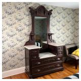 vanity surface over two full width drawers, with carved wood handles and decorative scrollwork and a