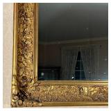 cove frame intricately decorate with grape and vine motif in high detail and relief, scroll corners,