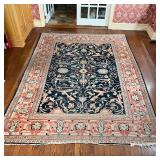 ANTIQUE GEOMETRIC CARPET | Overall pattern of vines and flowers on a blue field, within a salmon bor