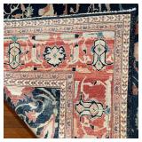 ANTIQUE GEOMETRIC CARPET | Overall pattern of vines and flowers on a blue field, within a salmon bor