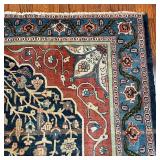 Having a central medallion with eight ballooning flowers, overall pattern of vines, flowers, and bud