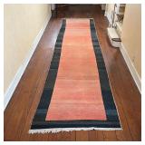 ANTIQUE RUNNER | Has a reddish field within a black-brown border, with abrash; l. 19 ft x 4ft 5 in