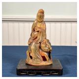 CHINESE HORN FIGURE | Carved horn figure with foo lion, on a flat wood stand; figure h. 6-1/4 in.