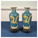 PAIR CHINESE CLOISONNE VASES | Green / teal cloisonne vases decorated with dragons, on carved wood s