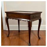 Wood side table with two pull-out writing surfaces, having a sculpted apron over cabriole legs termi