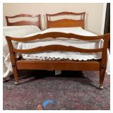 Antique style maple wood beds on casters, with sculpted headboards and footboards, twin size; each h