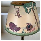 BRASS TABLE LAMP | With decorative shade painted with jungle animals; overall h. 22-1/2 in.