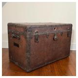 LEATHER STEAMER TRUNK | Antique steamer trunk of large size, brass bound; h. 25 x w. 39-1/2 x d. 22-
