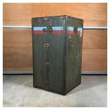 VINTAGE TRAVEL TRUNK | Upright, with painted stripes and initials "M.F." and with old stickers from 