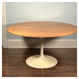 EERO SAARINEN TULIP TABLE | Tulip dining table with a wood top over a white base; h. 28-1/2 x dia. 5