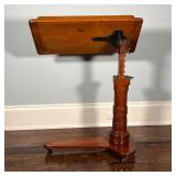 ANTIQUE WOOD EASEL | Antique easel on casters, adjustable height on a carved column; h. 45 x w. 29-1
