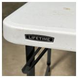 LIFETIME FOLDING TABLE | Folds in half for easy transportation, with carrying handle; folded 24 x 23