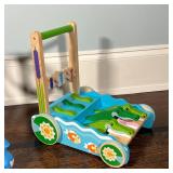 Melissa & Doug painted wood push toy with alligators (h. 15 in.) and a Pewi Elite "Jaxan" wheeled wa