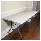 PDG FOLDING TABLE | Folds in half for easy transportation, with carrying handle; folded 35-1/2 x 29 