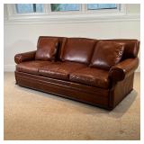 RALPH LAUREN LEATHER SOFA | Brown leather sofa, three cushions with two accent pillows, on a lower w