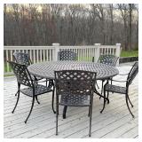  Outdoor patio dining set, comprising a large round table and six armchairs; table h. 28-1/2 x dia. 