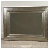 BEVELED OVER MANTEL MIRROR | Beveled glass mirror in a broad silvered frame; h. 35-1/2 x w. 48 in.