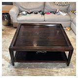 LACQUERED WOOD COFFEE TABLE | Dark wood low table with a galleried top and lower shelf; h. 18-1/2 x 