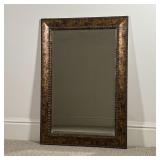 BEVELED GLASS MIRROR | Made in USA, beveled glass wall mirror in a bronzed and faux tack frame; h. 3