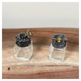 Small salt and pepper shakers, the lids decorated with a flower and a jeweled bee; each h. 2 in.