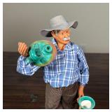 PAIR FRENCH POTTERY FIGURES | Including a man with pitchers and a woman carrying sticks, each on a w