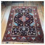 COLORFUL GEOMETRIC RUG | With central rust and teal medallion, intricate patterns and colorful embel
