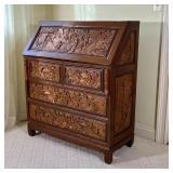 CHINESE CARVED SLANT LID DESK | Having blind carved panels with figures engaged in various scenes; h