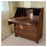 CHINESE CARVED SLANT LID DESK | Having blind carved panels with figures engaged in various scenes; h