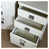 Pottery Barn side tables in the style of filing cabinets, with two small drawers of a larger bottom 