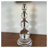 Table lamp designed as four graduated crystal balls stacked on top of crystal base with fabric shade