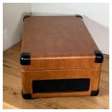 vinyl record player in a brown leather-wrapped case with carrying handle, model CR49